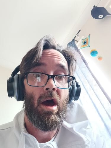 Customer wearing black Oneodio headphones at home